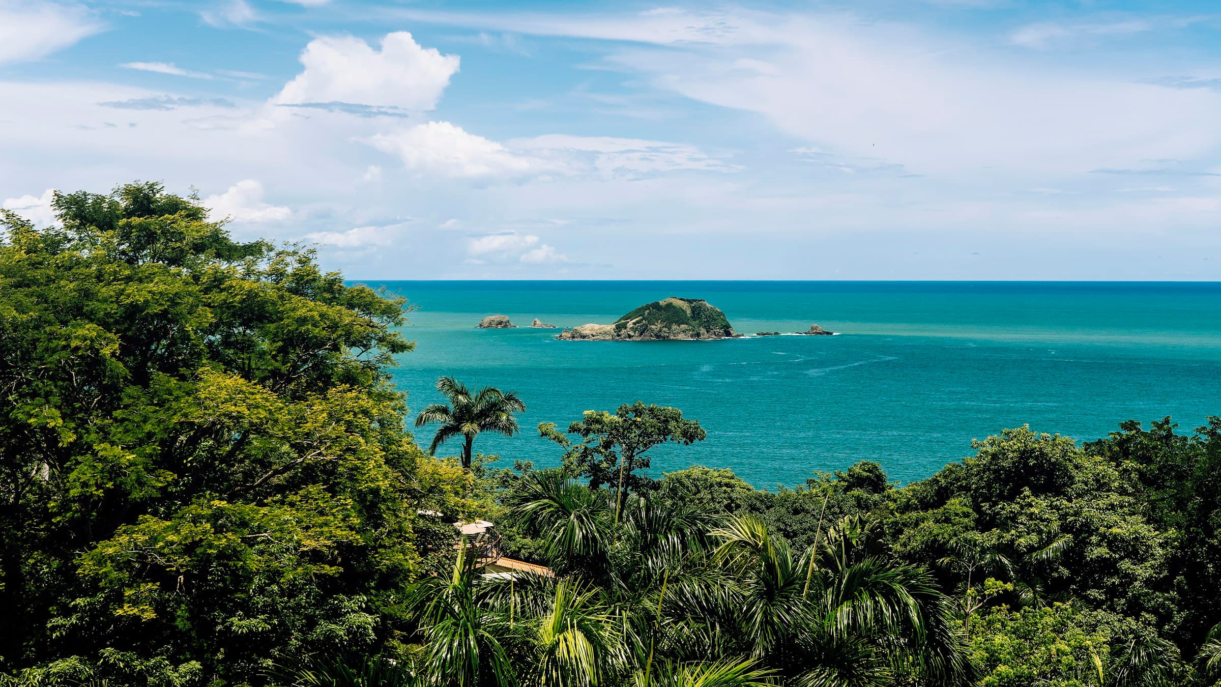 The rainforest of Manuel Antonio dropping down to the Pacific, with an islet on the horizon