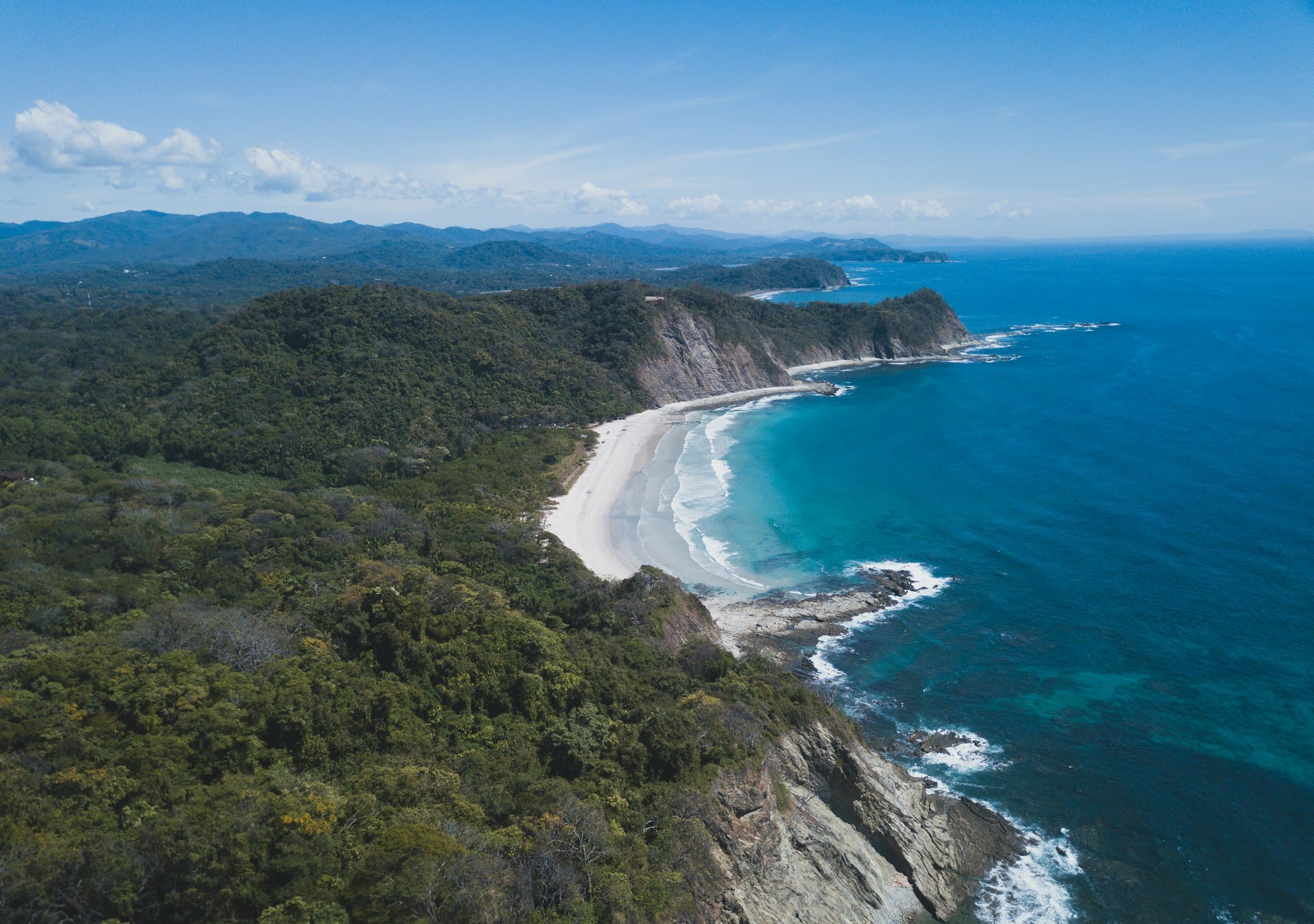 Playa Barrigona from the air, near Sámara: the Nicoya peninsula rainforest running down to white sand